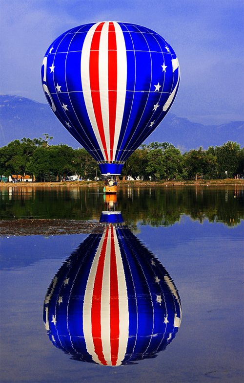 76 Stars and Stripes, Red, White, & Blue Hot Air Balloon Dipping in Prospect Lake, Memorial Park, Colorado Balloon Classic