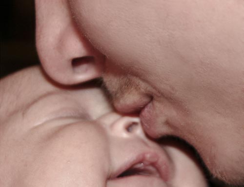Sweet Kiss of a Father and Child Photo